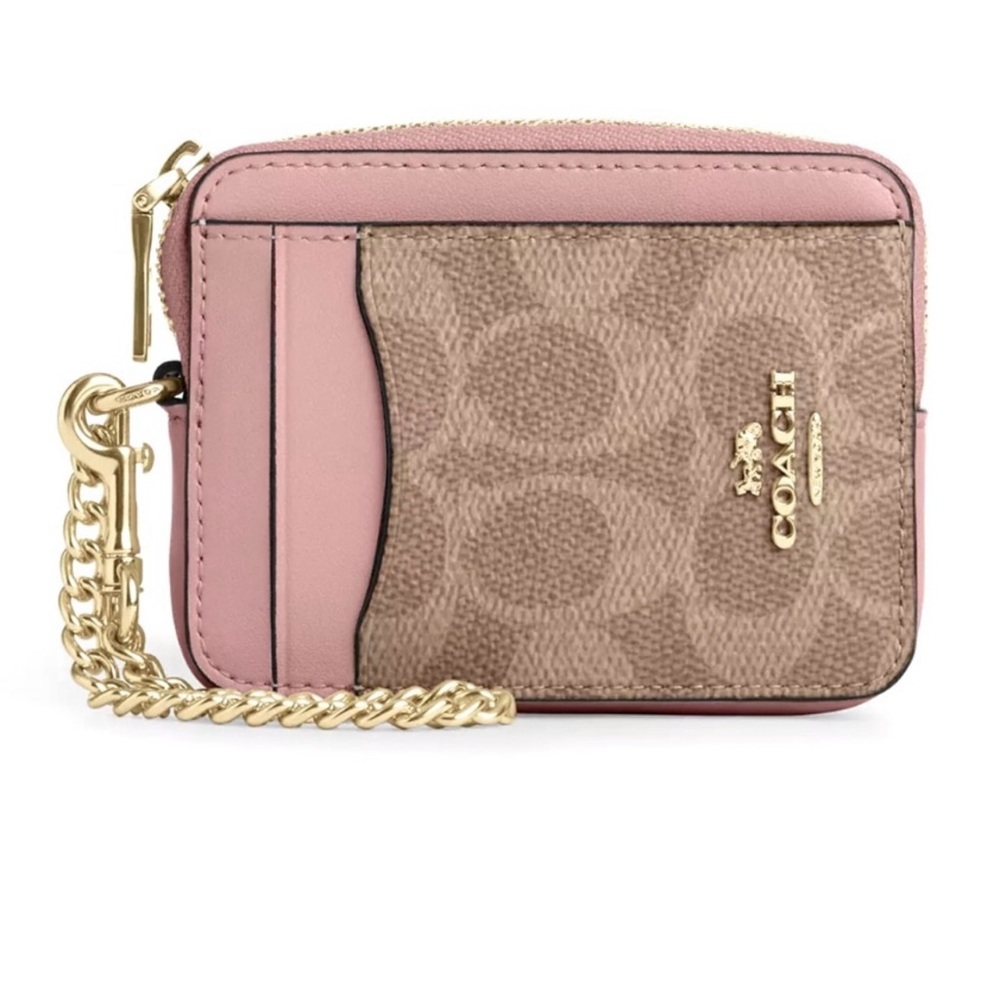 Coach zip card case in pink with gold hardware.